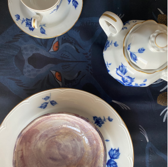 Closeup shot of Prado y Barrio WINTER Table linen with antique tableware.